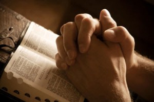 Praying Hands over Bible